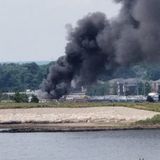 Smoke billows from burning cars at Fields Point