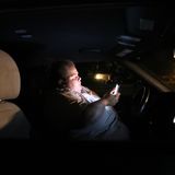 In a theme park parking lot at night, a worker sleeps in her car. This is life in America’s most visited city