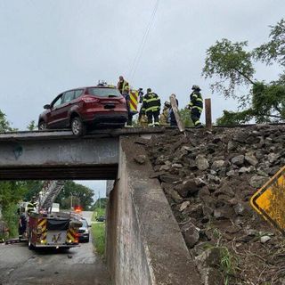 WATCH NOW: Vehicle drives up embankment, crashes onto train overpass