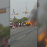 Several people help Dallas PD officers rescue man from burning car