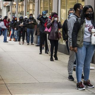 Chicagoans line up, at a distance, on first day of early voting