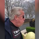 A man in Trump gear faces simple assault charge after he was seen breathing on women outside a Trump golf club