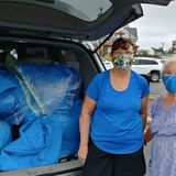 Nurses collect operating-room fabric that a retired couple is sewing into face masks for front-line workers