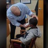 A middle schooler was insecure about his haircut. So his principal fixed it himself instead of disciplining the boy for wearing a hat | CNN