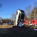 Driver injured when car upended after crashing into Taco Bell sign