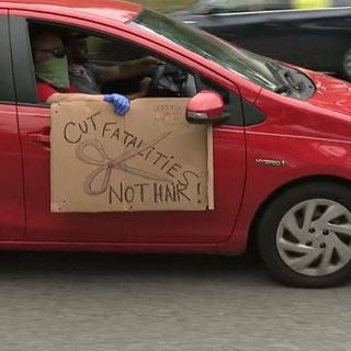 Protesters drive by Governor's mansion to show disapproval of Governor Kemp's decision to reopen businesses