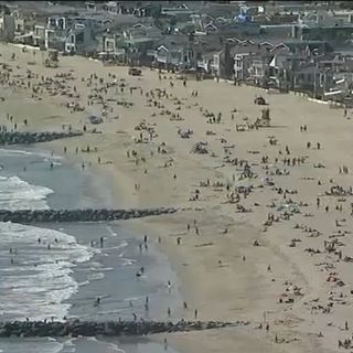 Tens of thousands flock to Orange County beaches as heat wave lingers over SoCal