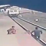 CCTV shows the moment a railroad worker snatched a child from the path of a train | CNN