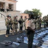 Tennessee National Guard troops lay down riot shields at protesters’ request