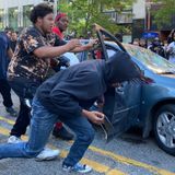 Videos show woman driving through crowd, nearly hitting marchers in Lansing protest