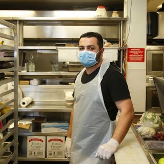 Armed with shotguns, a dozen men are guarding Russian restaurant against looters in downtown San Diego