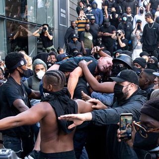 Black protester who carried injured white man through angry crowd says he was trying to avoid catastrophe | CNN