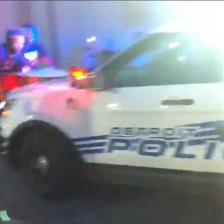 Detroit police SUV drives through crowd after protesters climb on hood