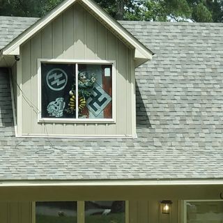 Benton neighbors concerned after man displays Nazi flags in front window