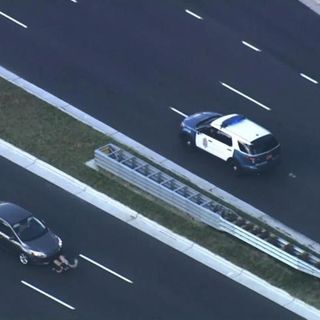 Sky 5: Protester on hood as vehicle tries to escape blockade on Capital Boulevard :: WRAL.com